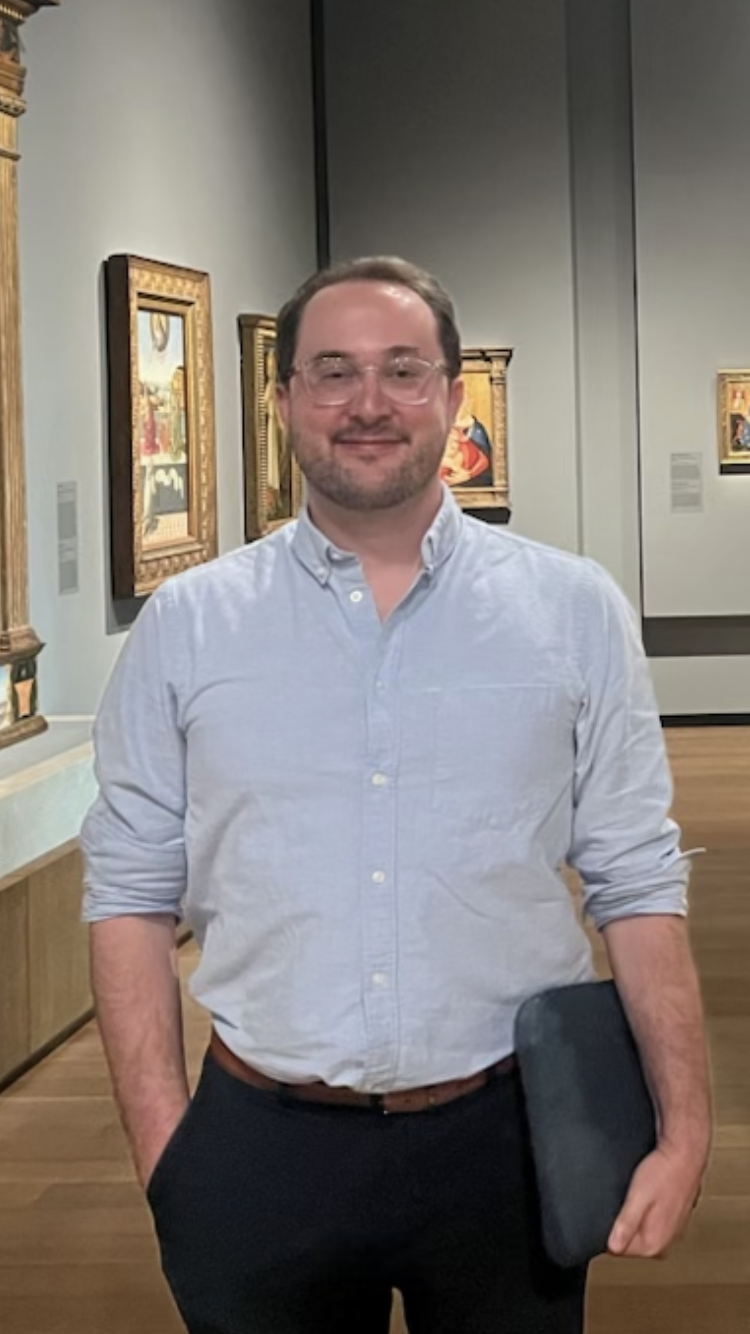 Young man in glasses and light blue shirtsleeves in the Early Renaissance galleries of the The Metropolitan Museum of Art